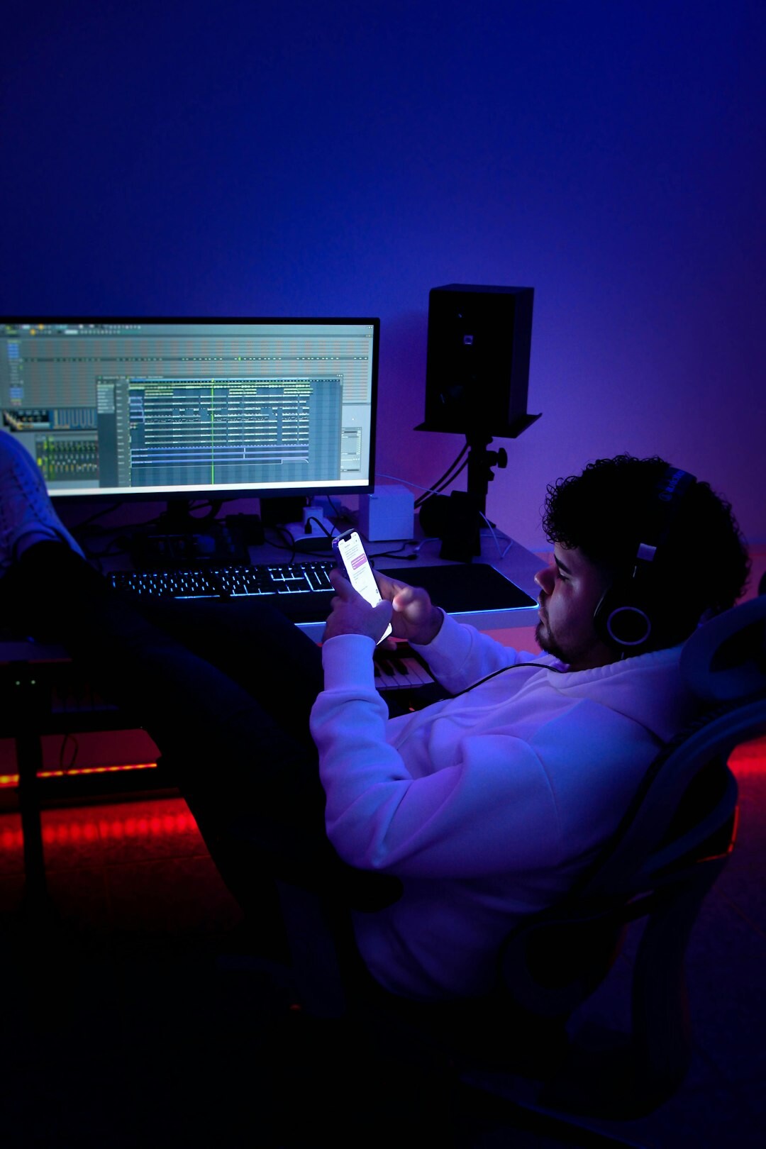 Young woman with headphones recording podcast in studio